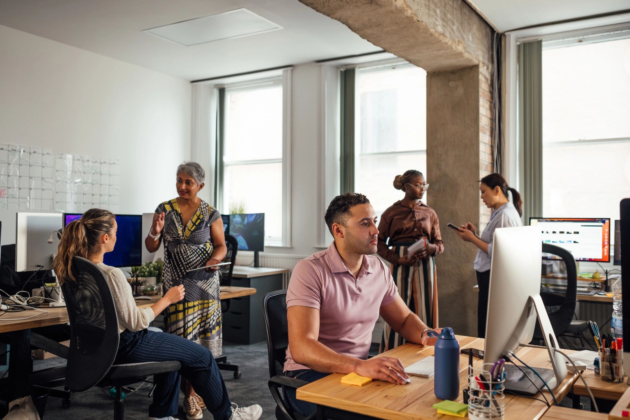 Office professionals collaborating at desks