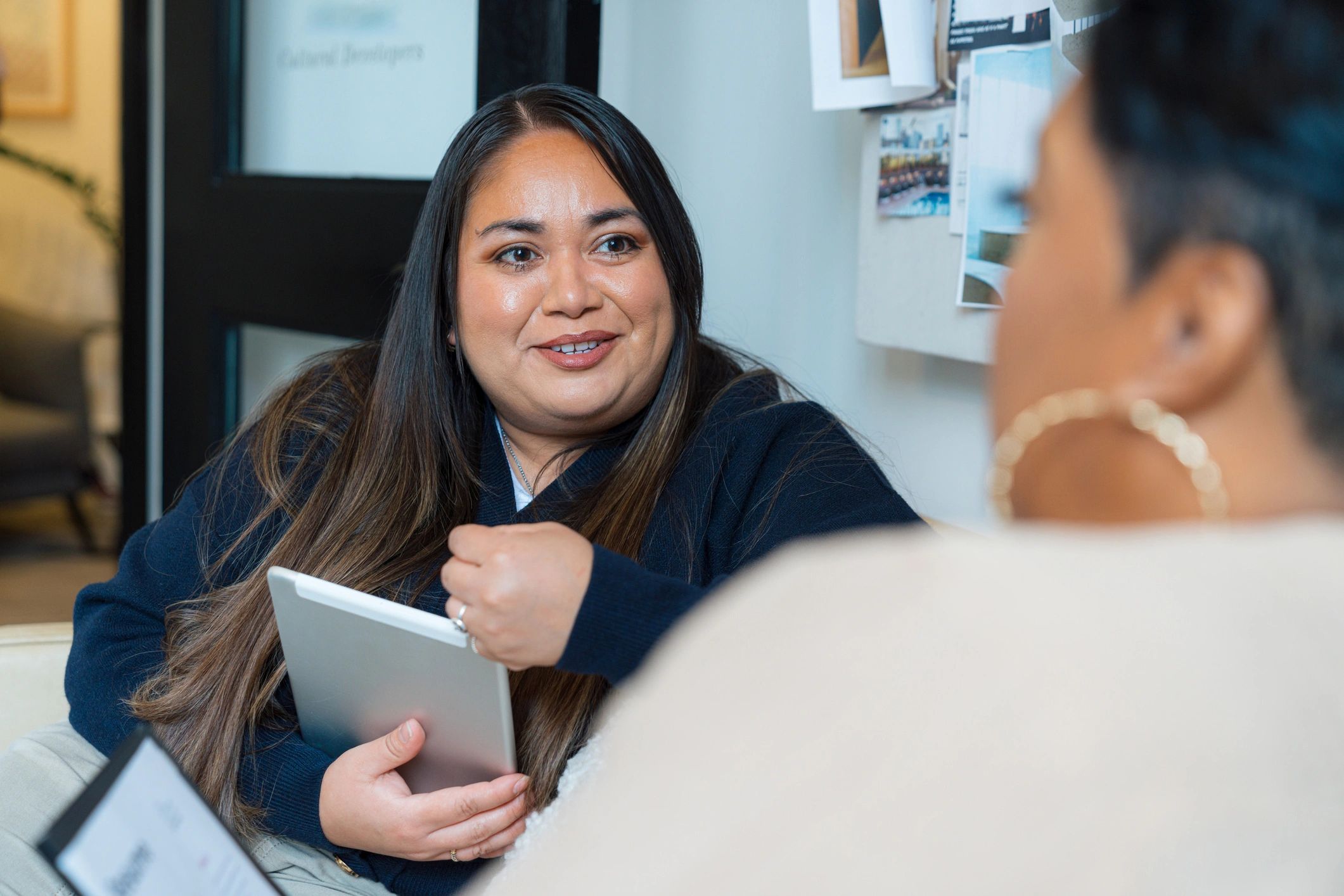 Latina / Hispanic Woman Speaking during a Meeting in a Modern, Business Casual Office Setting